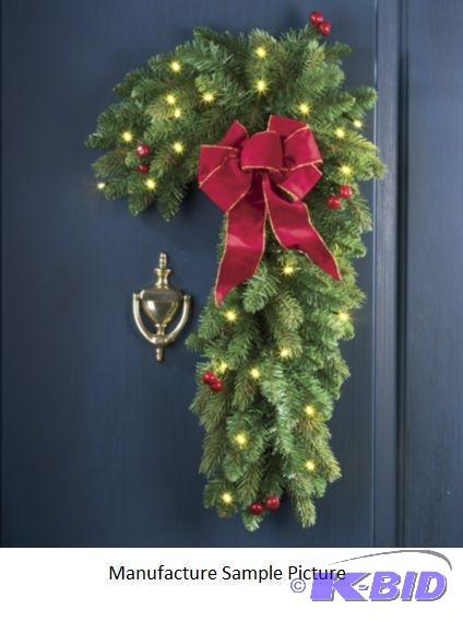 lot 94 image: Candy Cane Light Up Wreath - This faux pine a...