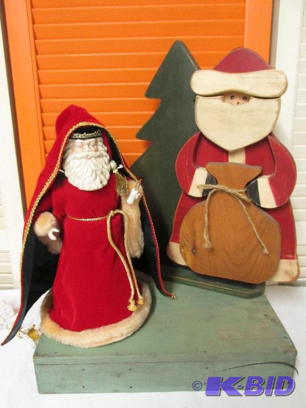 Two Santas One with a Porcelain Face and the Other Made of Wood