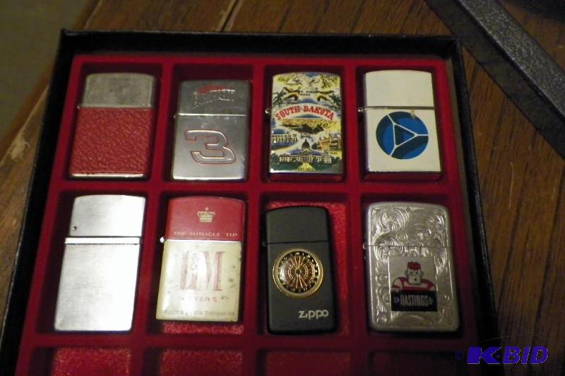 lot 69 image: 8 lighters including advertising pieces and a Zippo lighter. DISPLAY CASE IS NOT INCLUDED.