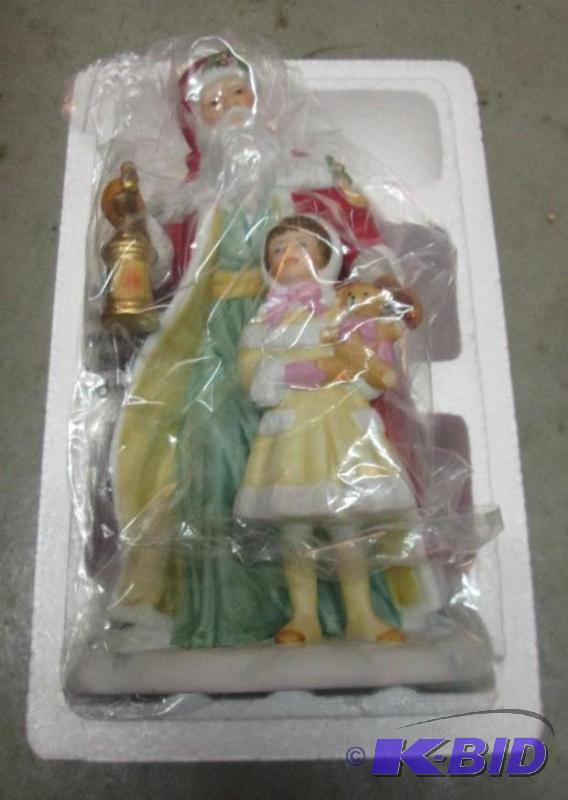 lot 133 image: santa and child statue...