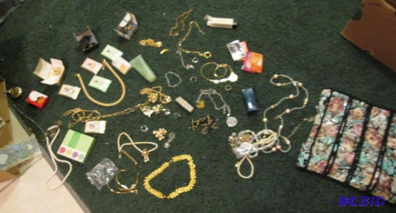 lot 35 image: large lot of Avon jewelery and hanging holder...