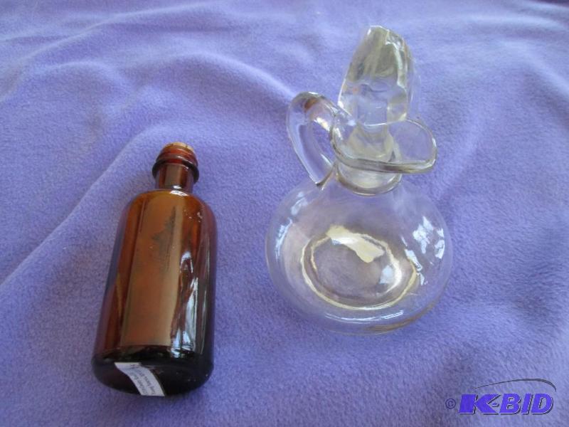 lot 367 image: Brown and clear glass bottles...