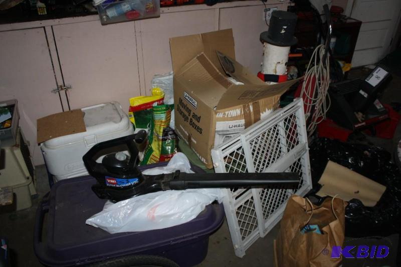 Contents In Front of Work Bench Pet Carrier Snowman Decoration Leaf Blower And More.
