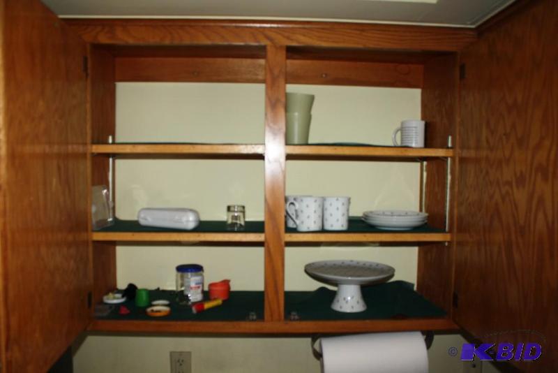 Shelf Contents Including Mugs, Plates, Serving Trays, And More.