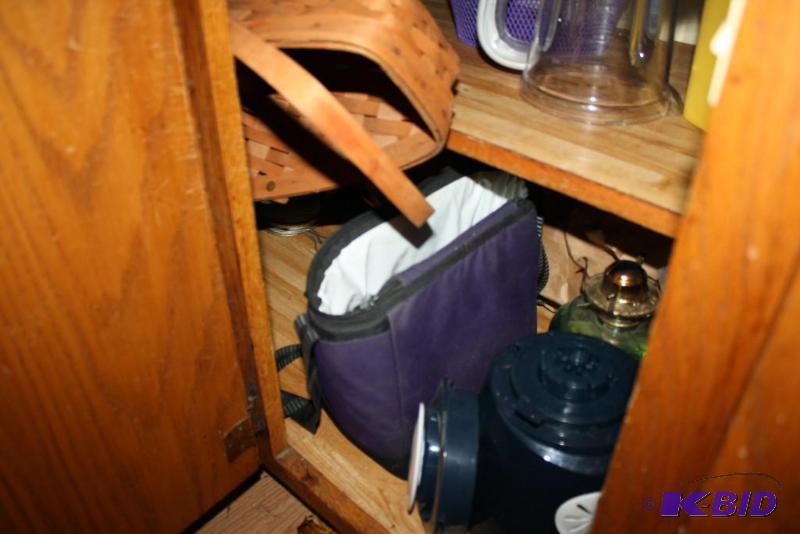 Shelf Contents Including Tongs, Thermos, Carrying Case, And More.