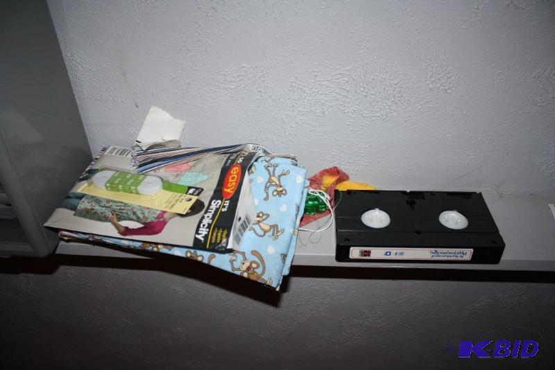 Shelf Lot Includes Storage Container, VHS, Tackle Box, And More.