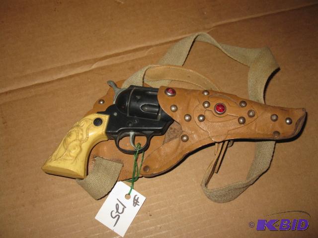 lot 125 image: Vintage toy revolver and leather holster, ver...