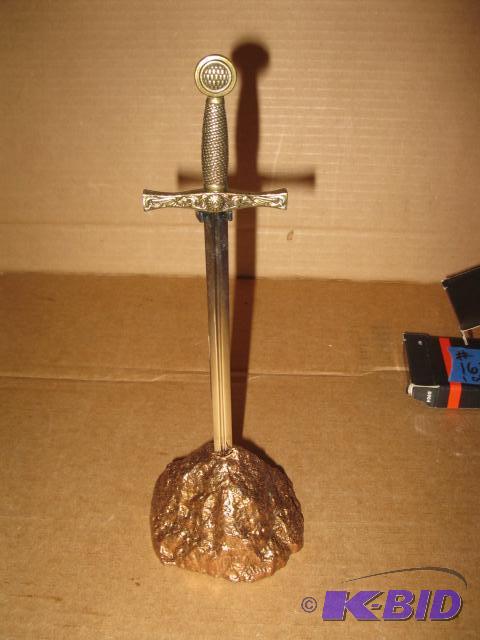 lot 162 image: 9 inch letter opener, Excaliber in rock stand...