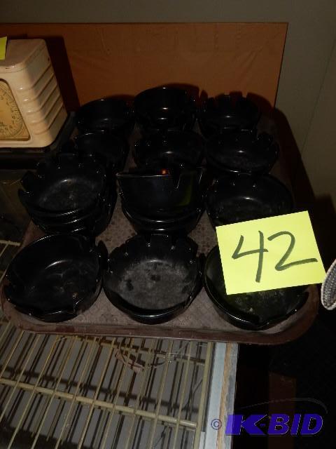 17, Black plastic ash trays...