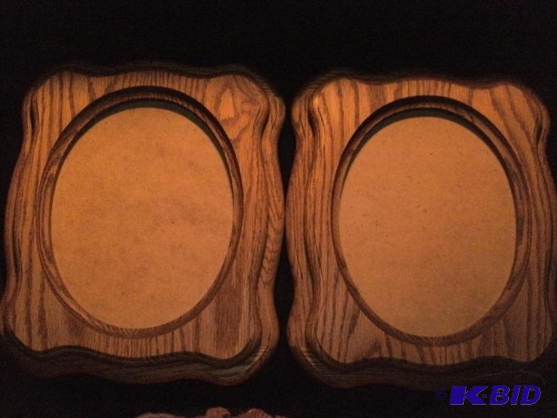 2 layered wood picture frames. There is small...