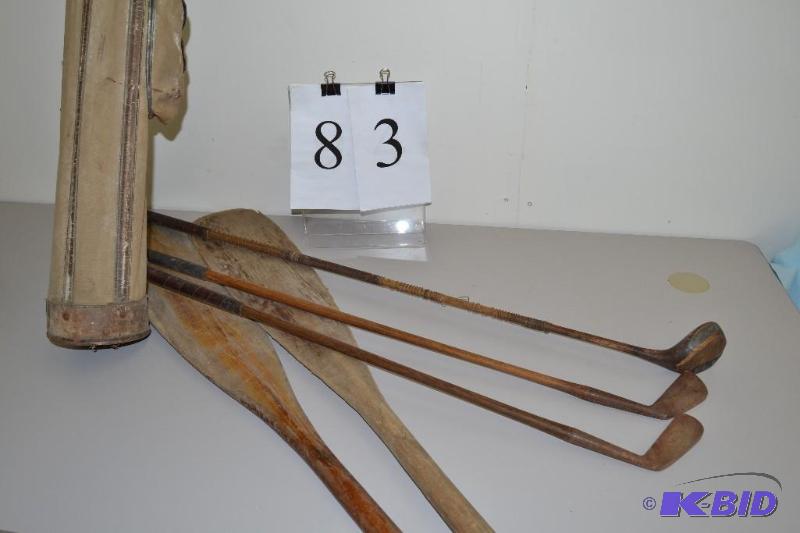 lot 83 image: The Golf King St. Andrews Special golf clubs, bag and canoe paddles.