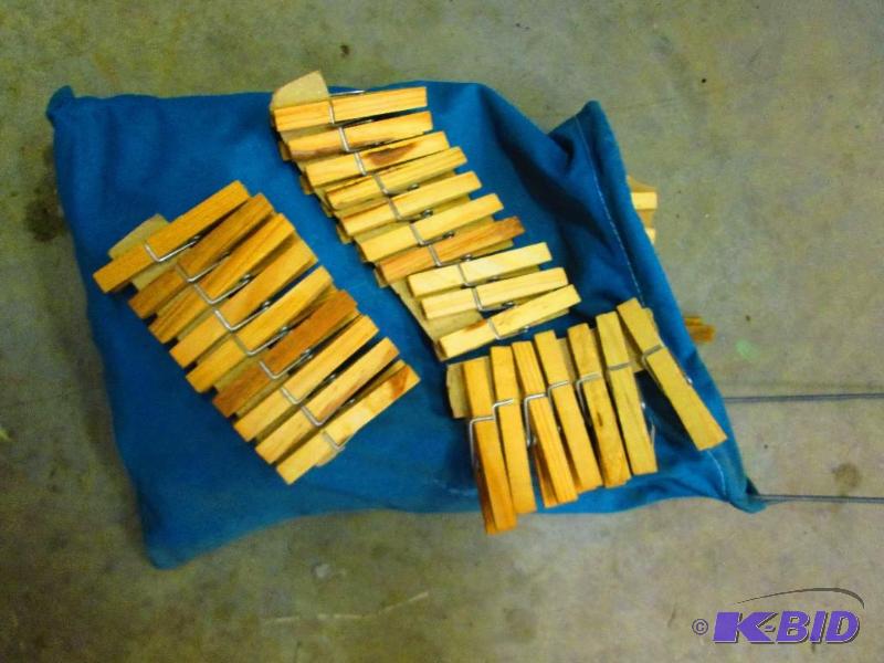 lot 9 image: Clothes Pins, new in a convenient cloth holde...