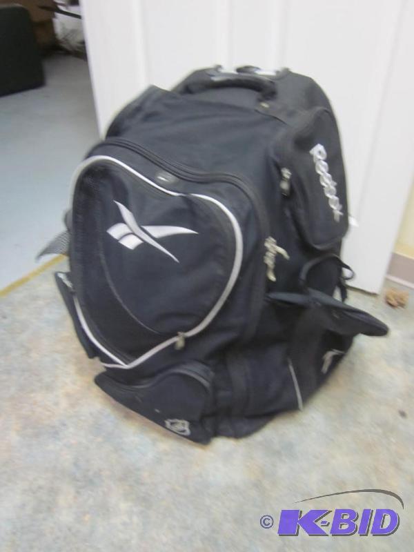 Large used Reebok hockey bag on wheels and ba...