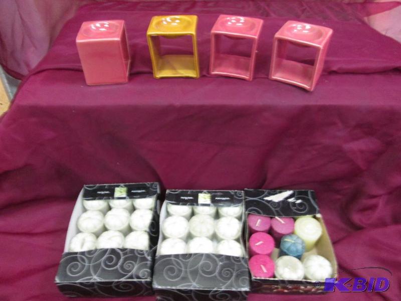 4 candle holders and 3 boxes of votive candle...