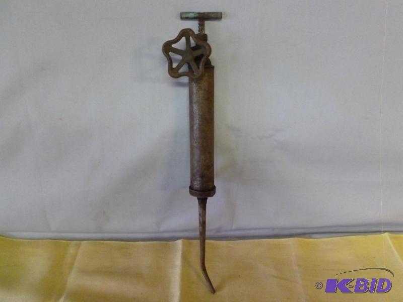 lot 112 image: Antique hand crank grease gun that measures 2...