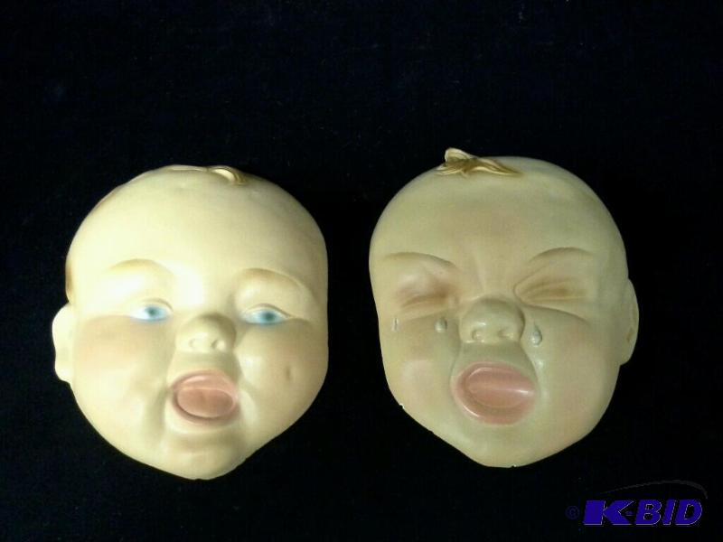 lot 107 image: Two vintage plaster babyface wall plaques