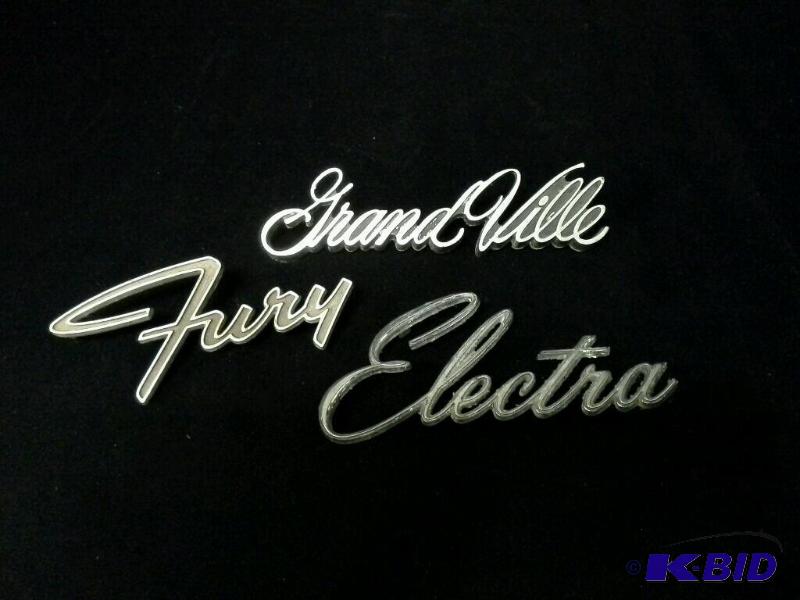 lot 95 image: vintage Grandville, fury, Electra car emblems