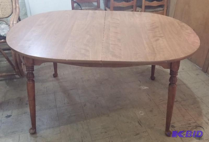 Oval table with 5 wicker bottom chairs. All a...