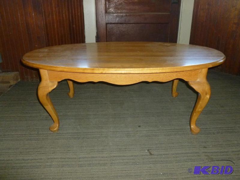 lot 221 image: Wooden oval shaped coffee table that measures...