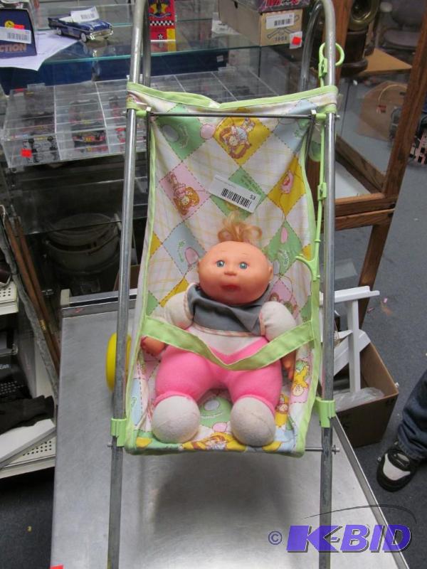lot 53 image: Cabbage Patch stroller and  doll