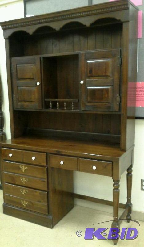 lot 54 image: Wood desk with hutch 4 drawers and two cupboards.