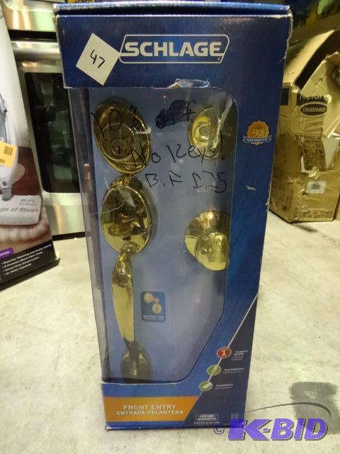 lot 47 image: Schlage front entry door lock set. Brass fini...