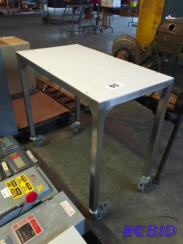 lot 65 image: Work table on casters. Plastic top, stainless...
