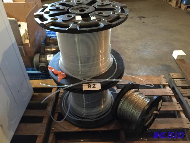 lot 92 image: Lot of 3 spools- 2 plastic tubing and one bra...