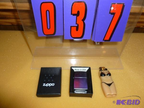 lot 37 image: New zippo lighter with mics lighter. As shown...