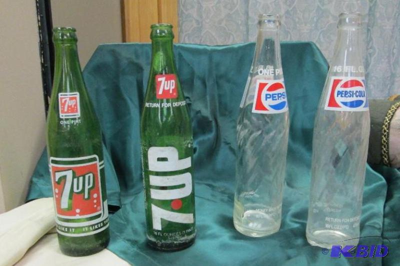 Hold Pepsi cola and 7 up bottles...