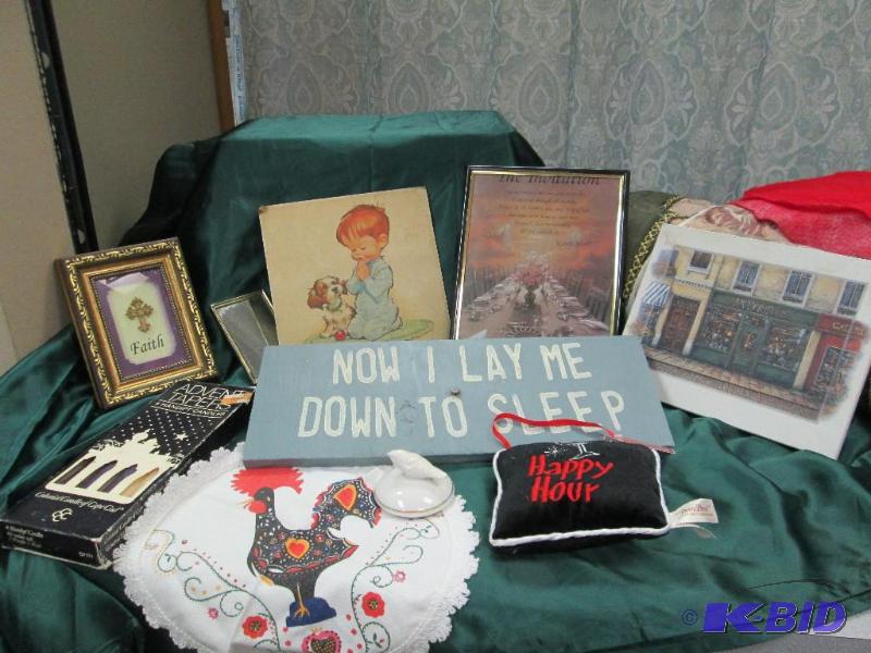 Assortment of pictures, candles, sign that sa...
