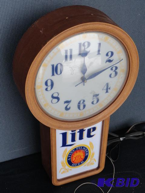 lot 139 image: Miller Lite clock, lighted and works, dated 1...
