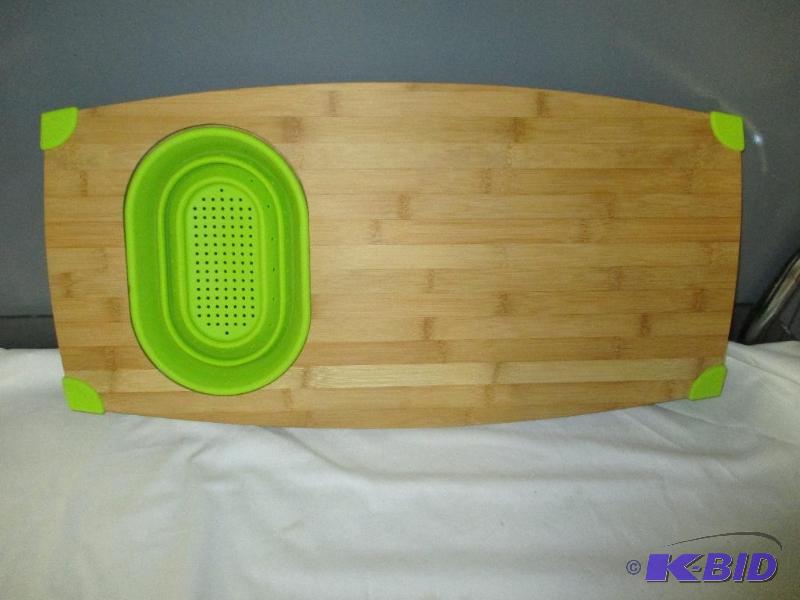 Cutting board with pop out strainer