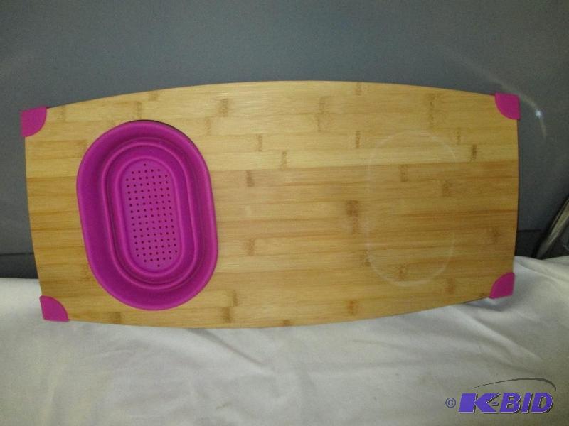 Cutting board with pop out strainer