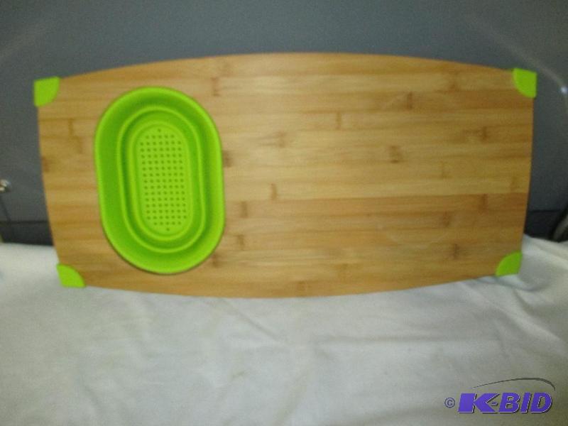 Cutting board with pop out strainer