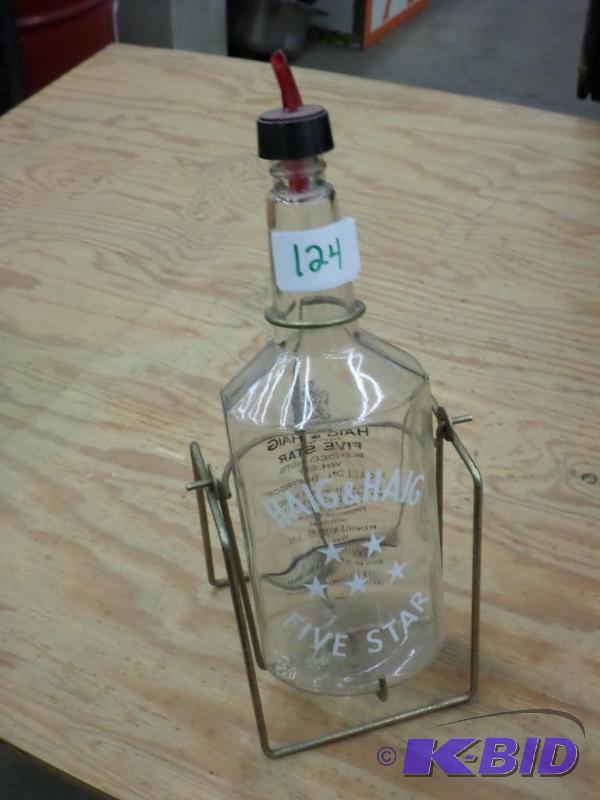 lot 124 image: Haig & Haig Glass Bottle On Hanging Rack...