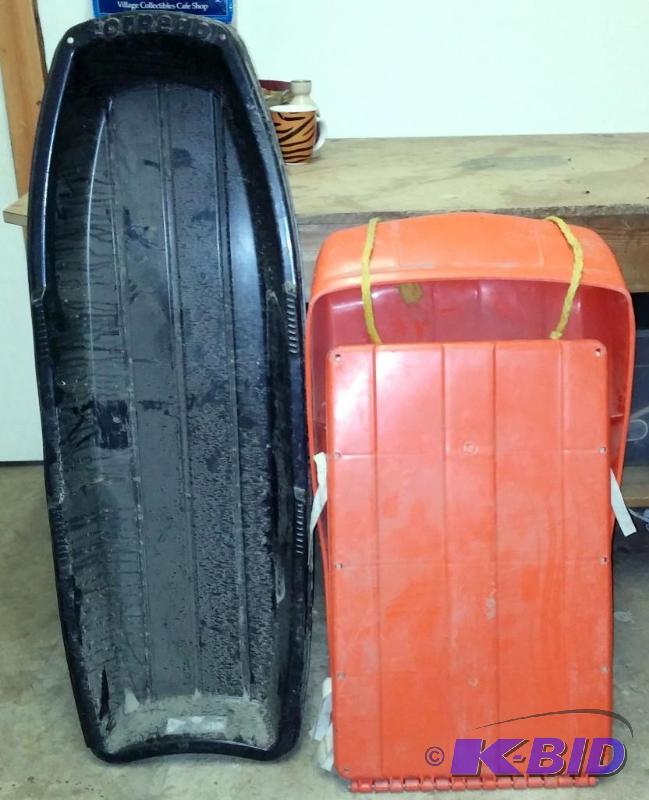 2 Sleds. The orange one is cushioned and fold...
