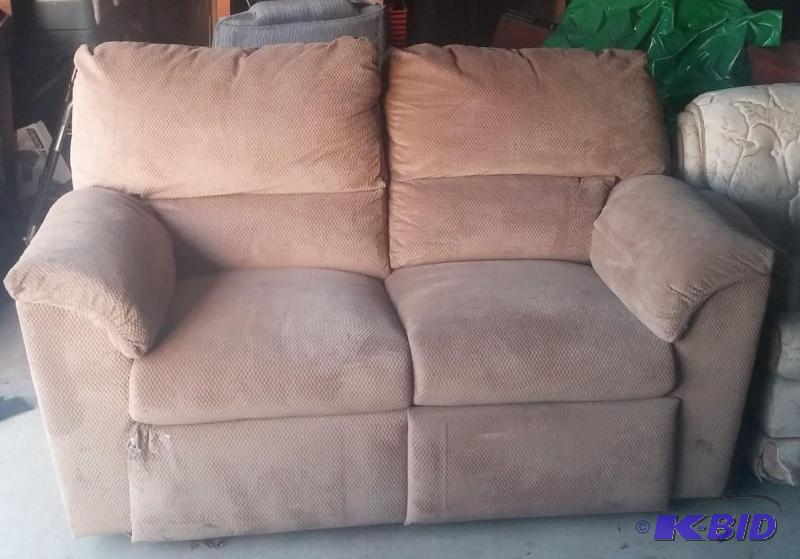 Tan love seat with recliners on both ends....