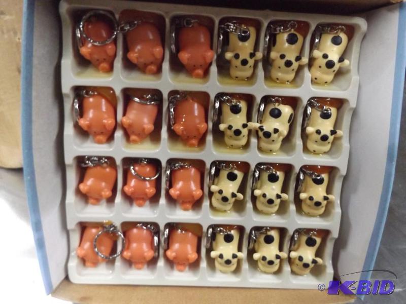 lot 39 image: Naughty Pig and Cow Key chains. 4 cases conta...