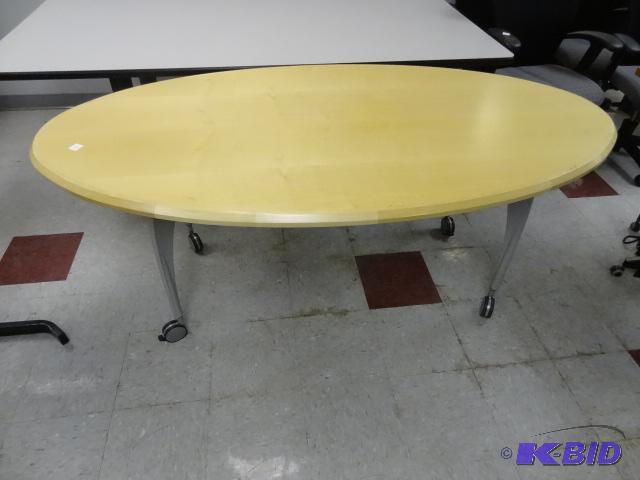 lot 123 image: Oval wood top table. Metal frame. On wheels. ...