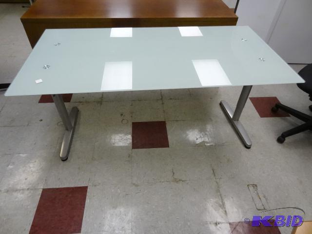 lot 142 image: Glass top desk with metal frame. 63 x 32 x 30...