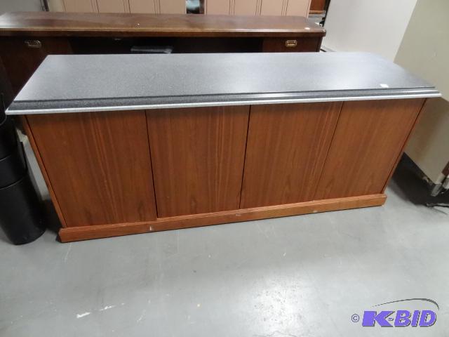 lot 316 image: 4 door wood credenza. Has a granite looking t...
