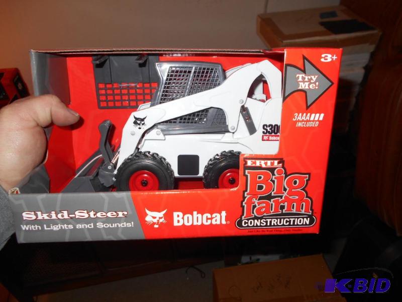 lot 112 image: Toy Bobcat s-300. Lights and sound. Brand new...