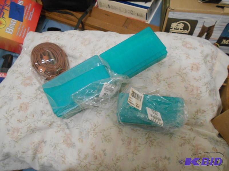 lot 289 image: rifle shell cases, plastic. And sling. New...