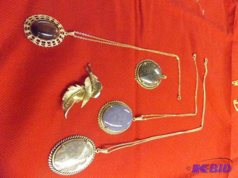 4 stone pendents with three chains, one gold leaf broach