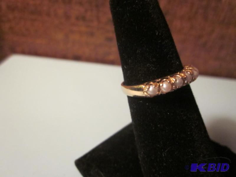 10 K gold ring, size 7, set with real pearls....