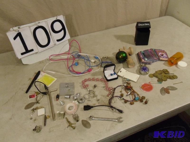 lot 109 image: Coins, Jewelry, Pokemon Cards, Ipod Cords, Ke...