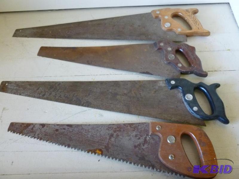 Lot of four large vintage hand saws that incl...