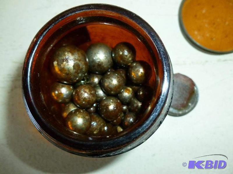 Vintage amber glass jar filled with mixed siz...