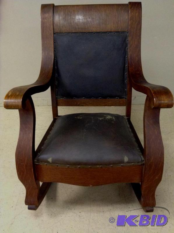lot 13 image: Vintage oversized Mission style wooden rocker with leather tack seat and back